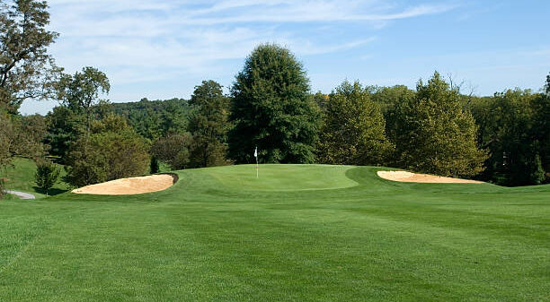 A view of the green from the fairway on a beautiful day.